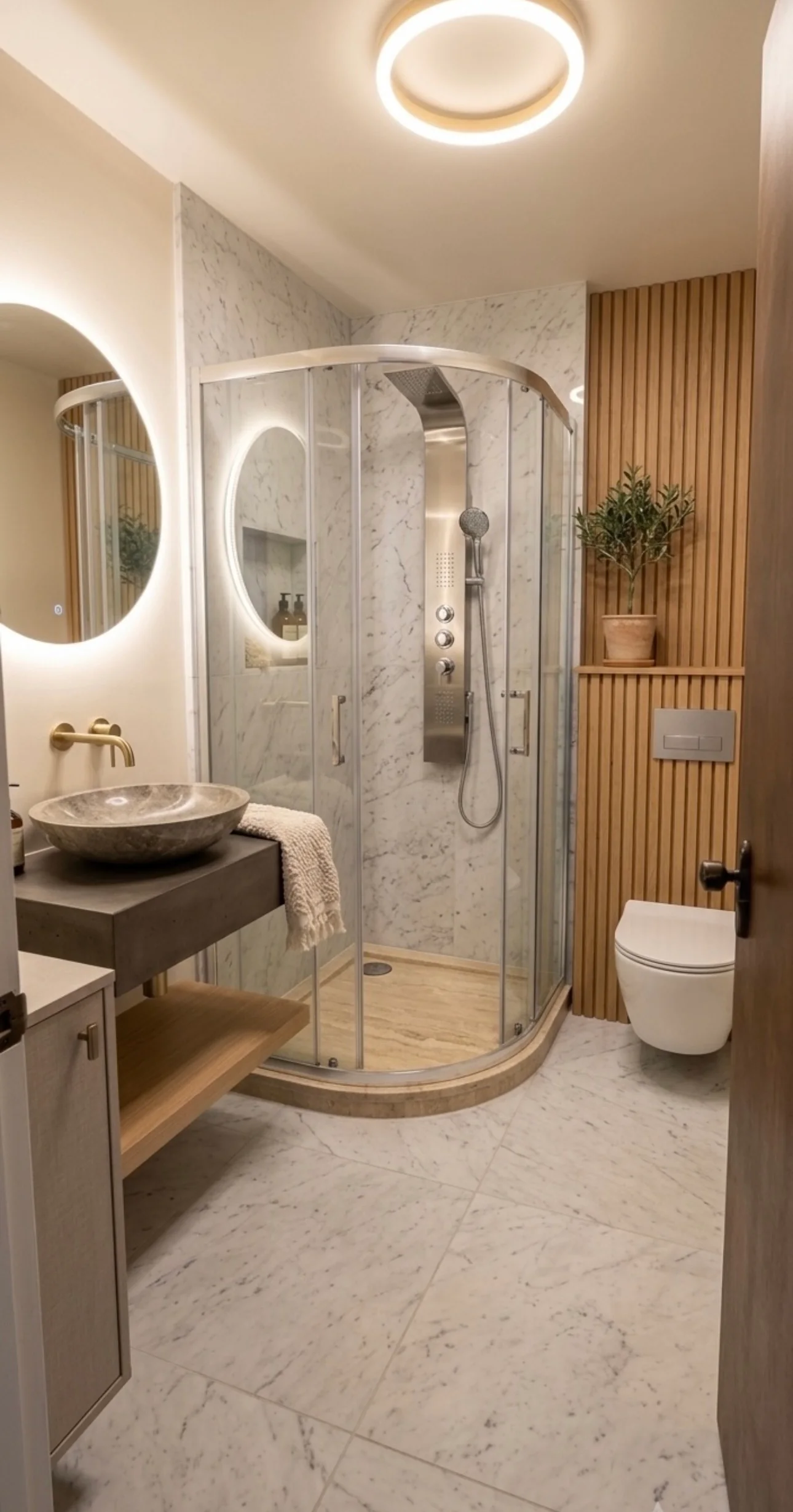 Bathroom with curved glass shower, illuminated mirror, stone basin and timber wall panelling